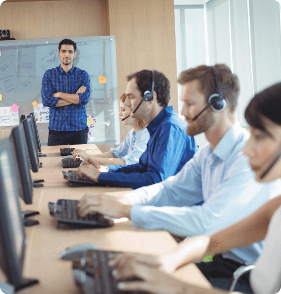 several determined agents working on their computers, clean office space